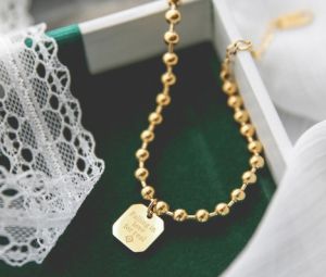 TT4324 - Lắc tay titan bi thẻ Falling in love for real (màu vàng)