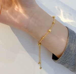 TTN6599 - Lắc tay titan dây rút bi trơn mix bi nhám (màu vàng)