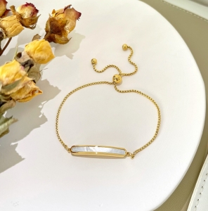TTN8449 - Lắc tay titan thanh xà cừ dây rút (màu vàng)
