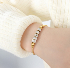 TTN8553 - Lắc tay titan dây rút charm đá (màu vàng)