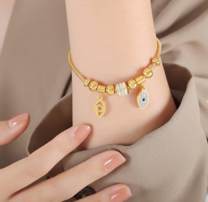TTN8787 - Lắc tay titan phối charm đôi mắt (màu vàng)