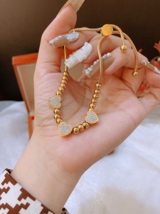 TTN8795 - Lắc tay titan bi charm tim đá dây rút (màu vàng)