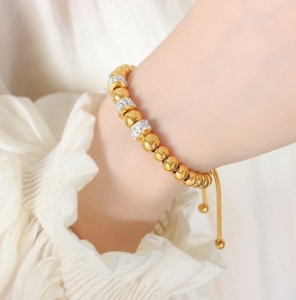 TTN10858 - Lắc tay titan dây rút phối charm (màu vàng)
