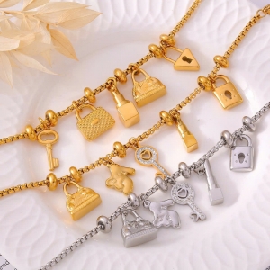 TT11100 - Lắc tay titan phối charm túi son (màu trắng/màu vàng)